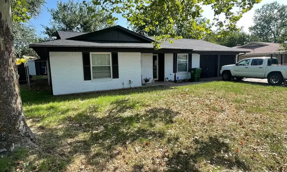 Professional roofing crew working on a residential roof in Okmulgee